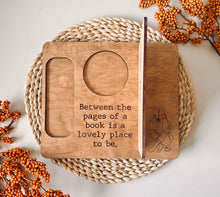 Load image into Gallery viewer, &quot;Between the Pages&quot; sitting with a book
